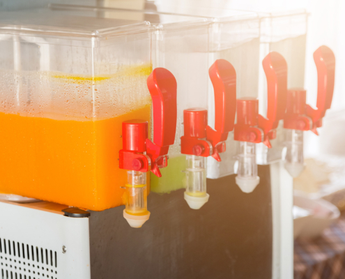 Side view of a juice dispenser with red handles