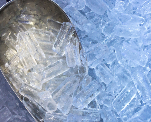 Close up of aluminum scooper with ice