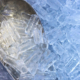 Close up of aluminum scooper with ice