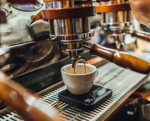 Espresso machine pouring coffee into cup