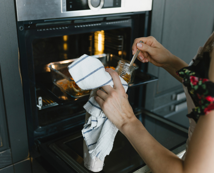 Beautiful young woman preparing dinner in the kitchen