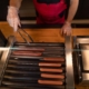 Worker at convenience store rotating hot dogs
