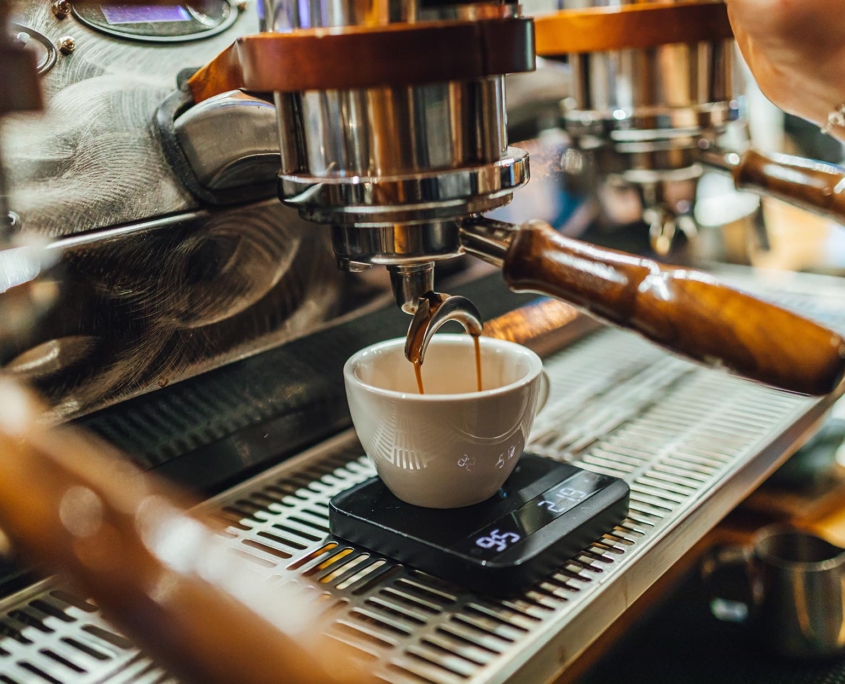 Worker brewing espresso